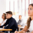 Young girl listening and taking notes during foreign language courses - Краевое профобъединение